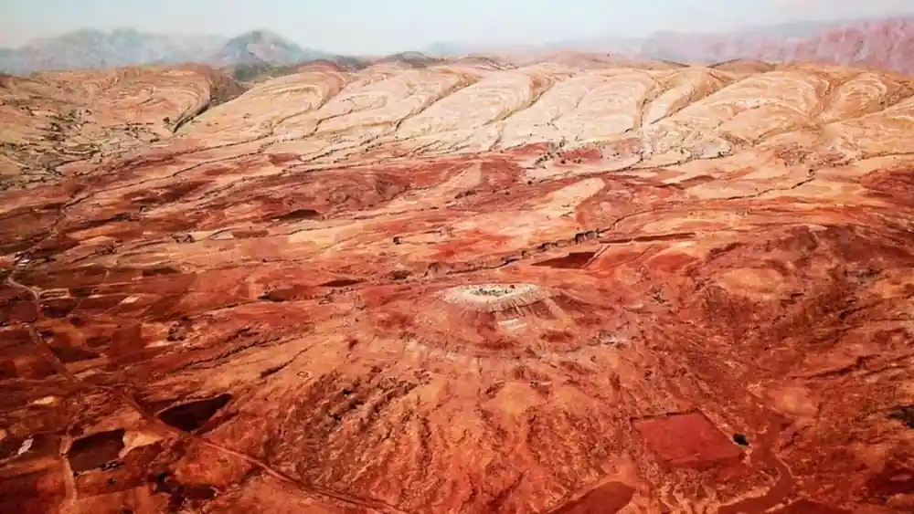 Aerial view of the red upturned strata curving across the crater
