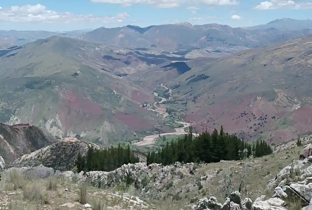 A deep valley with a river and a road winding along the floor