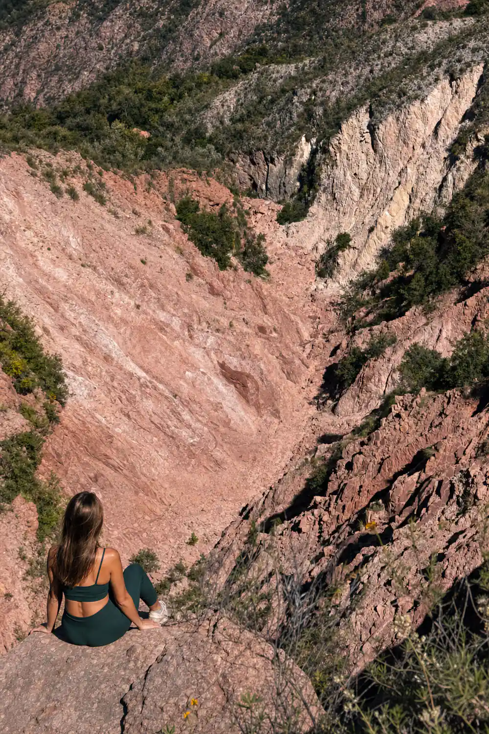 A red-walled gorge cutting steeply down through the rock